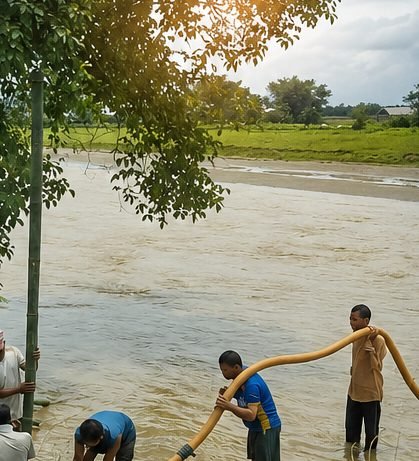 Crew working in shallow water beside a high river channel